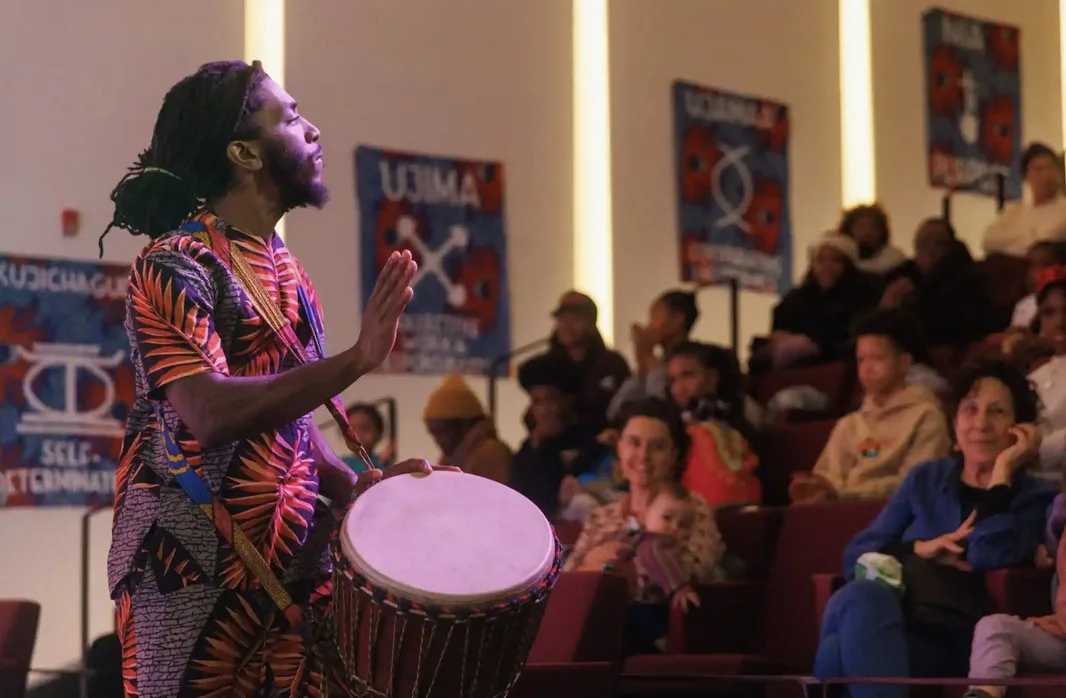 Man plays a drum at a Kwanzaa holiday weekend event in New York