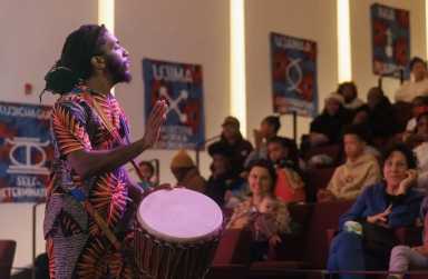 Man plays a drum at a Kwanzaa holiday weekend event in New York
