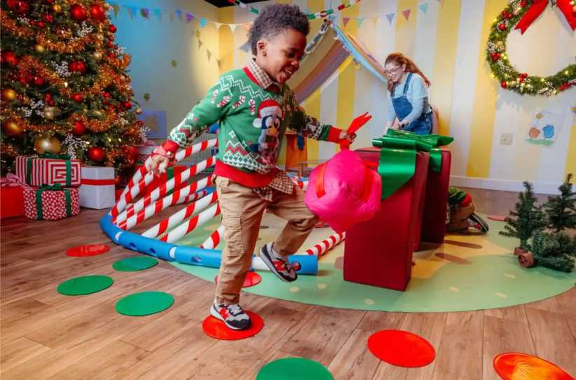 Things to Do with the Kids This Weekend in New York, boy running around and playing next to Christmas tree and holiday decorations