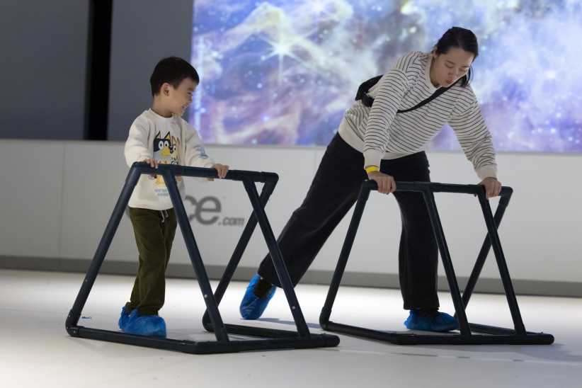 Mom and child skating at Space Glide at New York Hall of Science