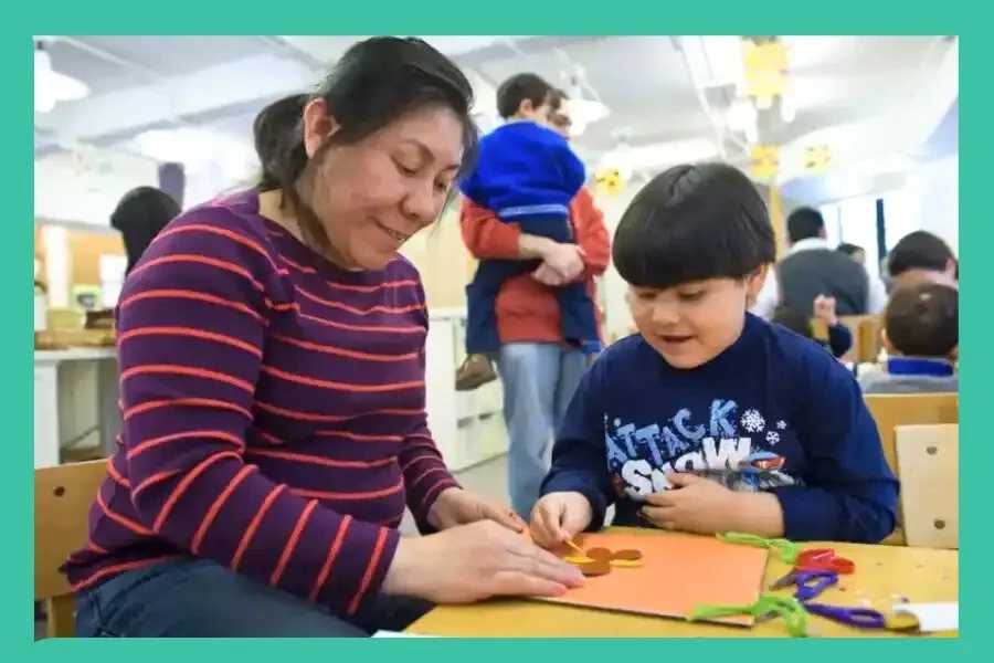 Woman and little boy smiling as they create an art project at Wave Hill, one of the things to do with the kids this weekend in NYC