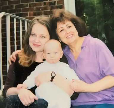 Mom and me sitting on her front porch with my son on my lap
