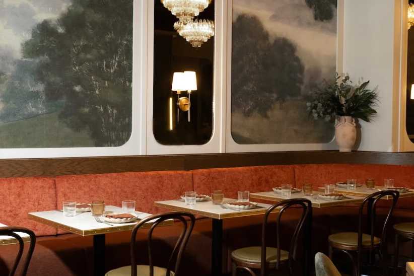 Table and chairs inside Markette restaurant in NYC