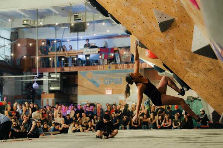 Climber on steep indoor bouldering wall at GP81 in Bushwick Brooklyn during competition