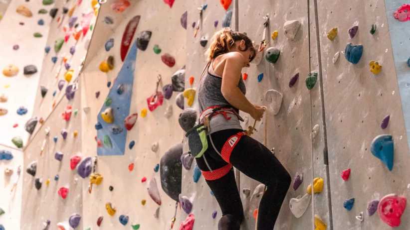 Climber using rope system on indoor wall at MetroRock Bushwick Brooklyn