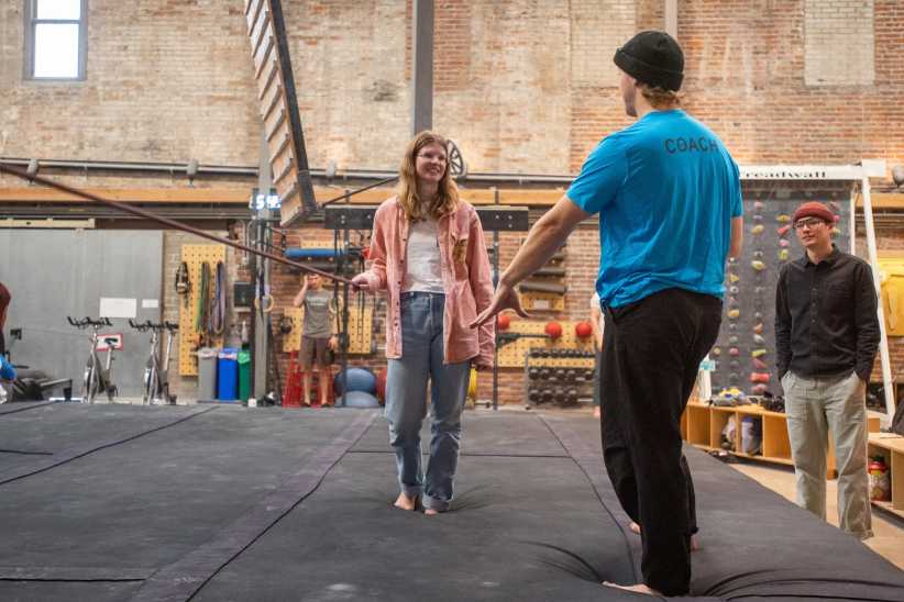 Coach guiding beginner during climbing class at Vital Climbing Gym in NYC