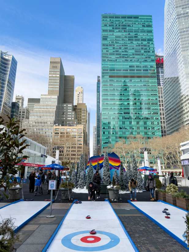 Winter Games activities like curling at Bank of America Winter Village at Bryant Park during the 2025-2026 season.