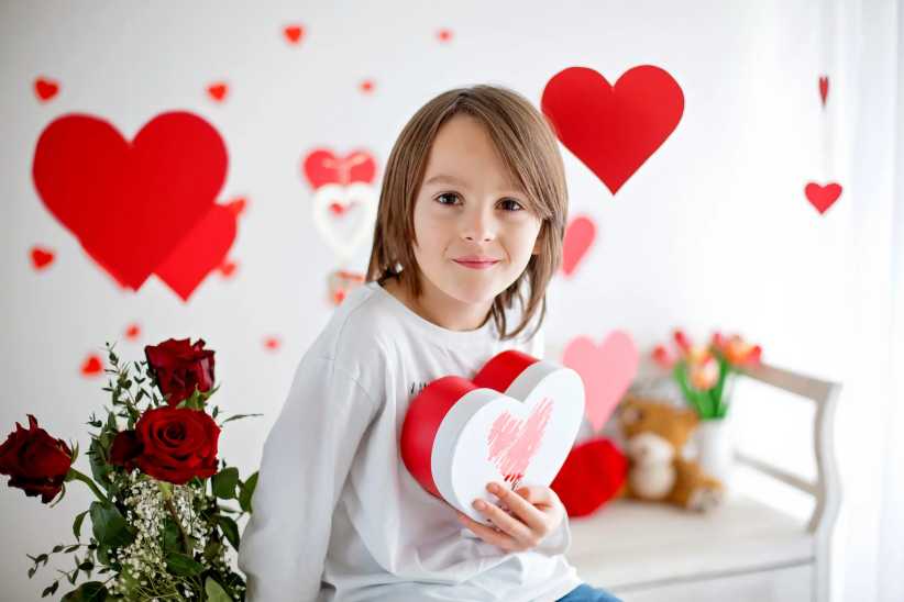 Cute, Easy, and Doable Valentine’s Day Gift Baskets for Kids: Little boy making Valentine's Day gift baskets