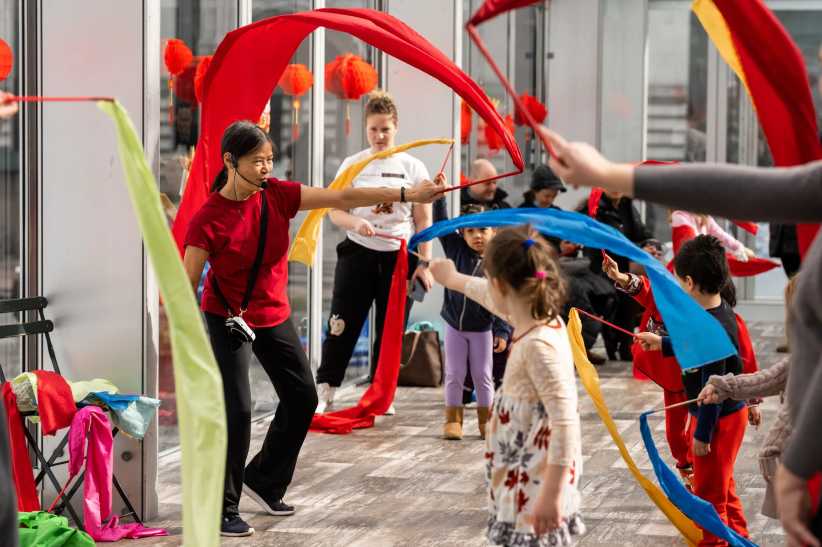 Kids playing and waving ribbons at the Lunar New Year celebration at Bryant Park