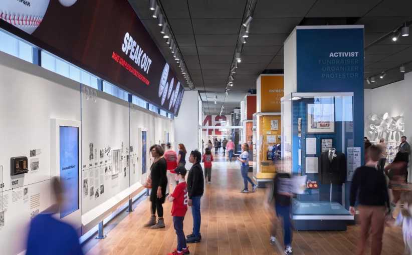 People standing in a museum looking at exhibits. 