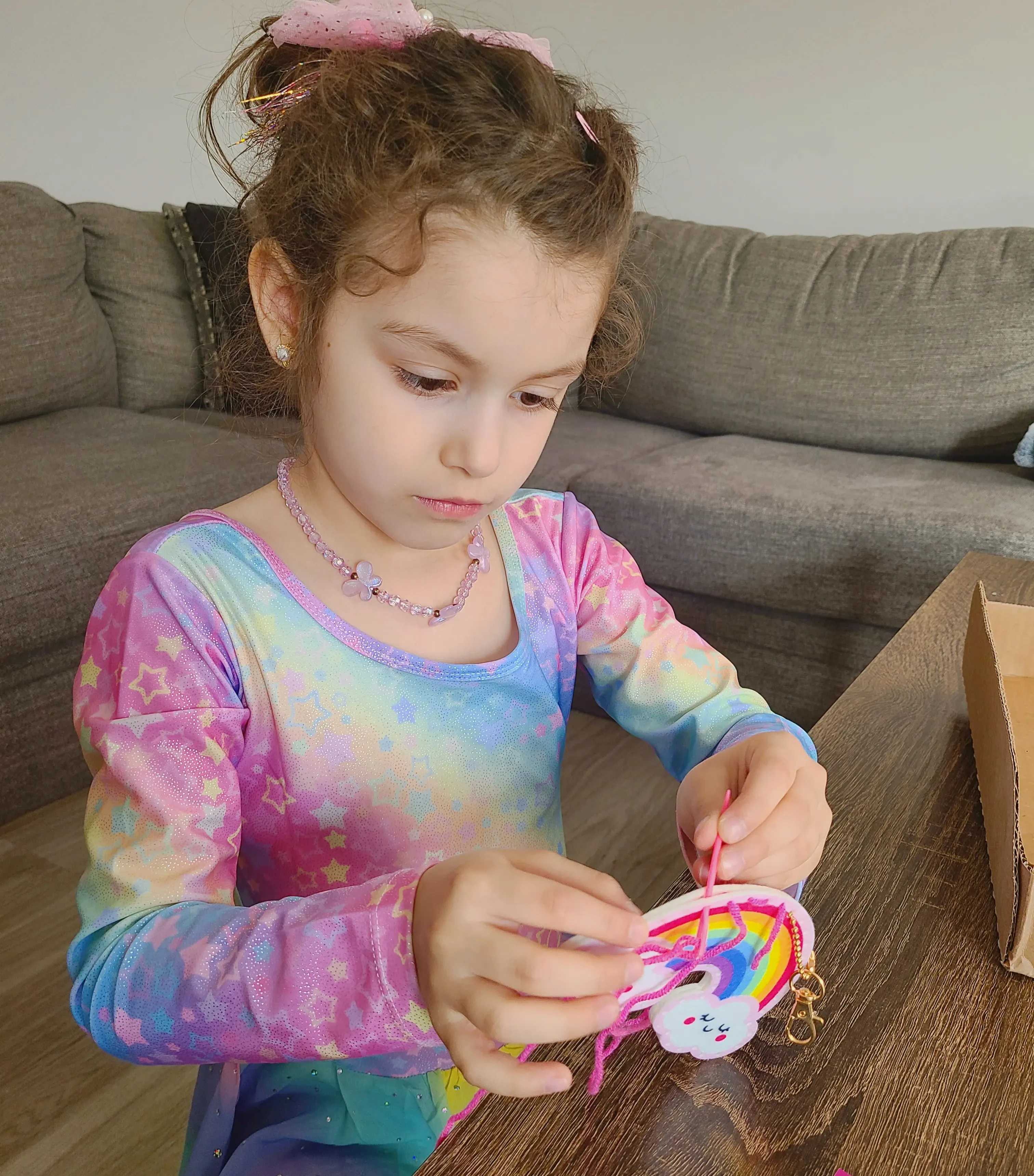 Adorable Quiet Play Ideas for Kids That Encourage Calm, Creativity & Confidence: Girl sewing a keychain in felt