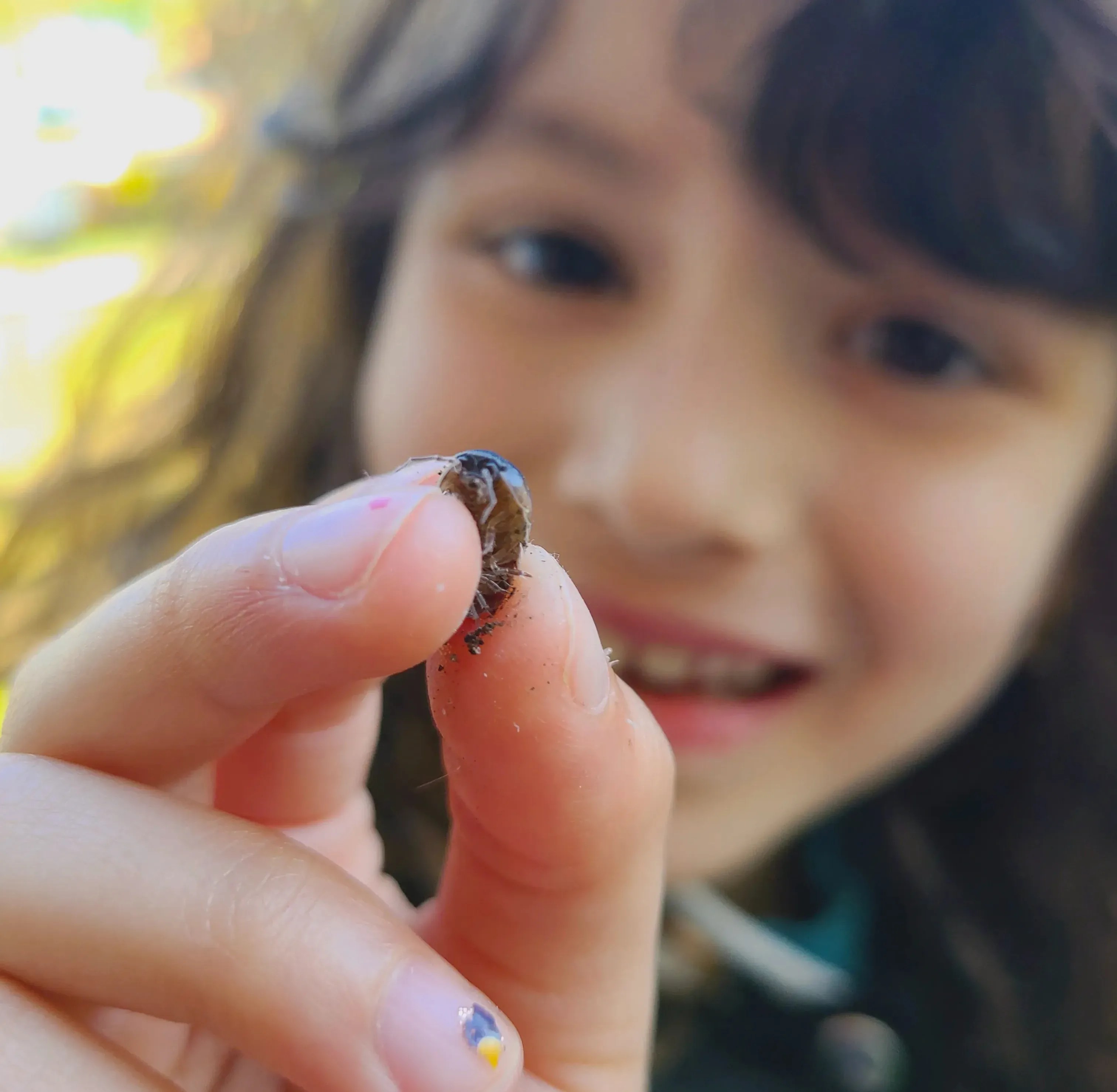 Adorable Quiet Play Ideas for Kids That Encourage Calm, Creativity & Confidence: Girl holding a bug