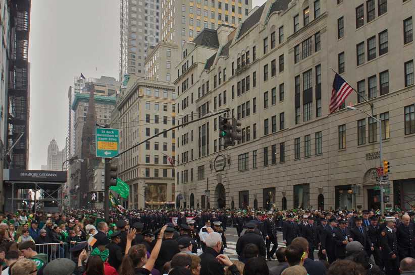 St. Patrick's Day parade and background. 5th Avenue. Young child in St Patrick's Day hat watching the parade, NYC St. Patrick’s Day Parade: Tips for Taking Kids