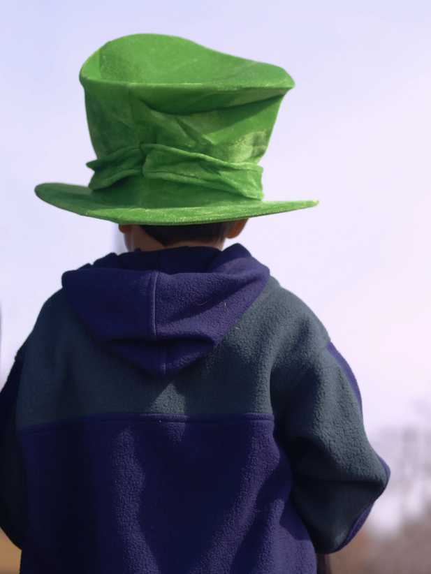 Young child in St Patrick's Day hat watching the parade, NYC St. Patrick’s Day Parade: Tips for Taking Kids