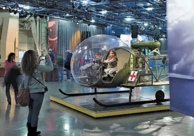 Child sitting in makeshift vehicle at Intrepid Museum. 9 NYC Museums You Can Get Into Free This Weekend (If You Have This Card)