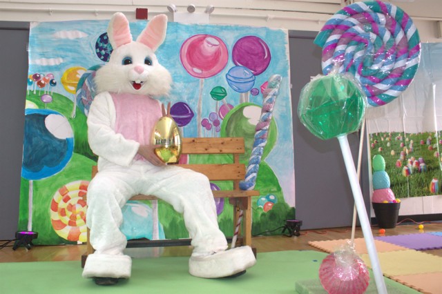 easter bunny in front of candy backdrop